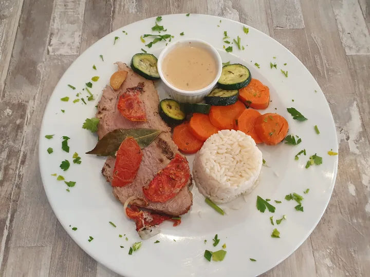 Tranches de viande rôtie, dôme de riz, carottes, courgettes et sauce